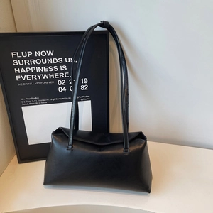 Minimalist black leather shoulder bag with long handles and a rectangular flap design
