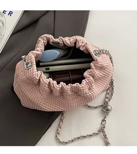 Top view of pink pleated chain bag showing interior storage for phone and cosmetics