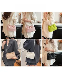 Detailed view of women pleated cloud crossbody bags in multiple colors with chain straps