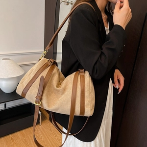 Beige suede tote bag with brown leather straps shown on model for casual commuting style