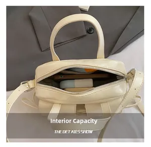 Internal capacity of cream leather tote bag showing space for phone and wallet
