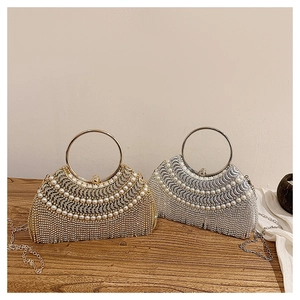 Close-up of gold and silver evening clutches with rhinestones and pearl accents