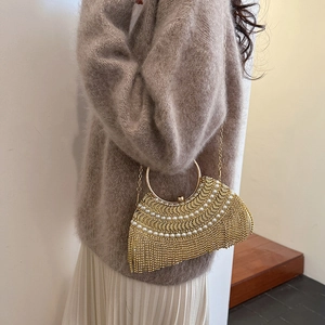 Elegant gold fringe evening bag with pearls, round metal handle and a delicate chain strap