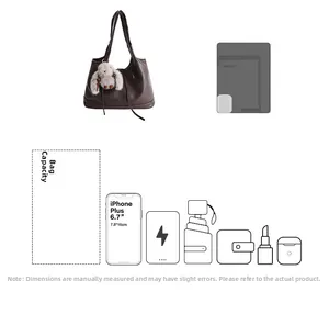 Detail view of large dark brown tote bag capacity with plush bunny charm and accessories