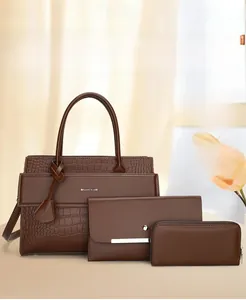 Three-piece set featuring dark brown faux crocodile skin tote, clutch, and small wallet