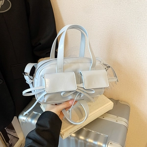 Light blue bow shoulder bag with glossy finish and double front flap pockets