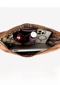 Interior view of brown pebble leather tote showing spacious striped lining and compartments