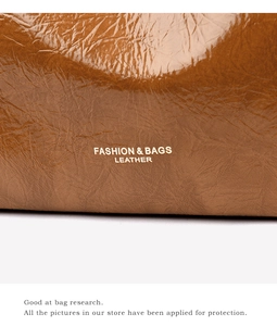 Close-up of brown crinkled leather tote featuring gold FASHION & BAGS lettering