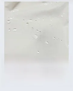 Détail du matériau en toile grise imperméable avec gouttes d'eau sur la surface du sac