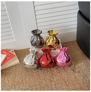 Detailed macro view of five shiny metallic drawstring bags in diverse candy colors