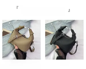 Close-up of khaki and black leather handbags with lychee grain and metal buckle detail
