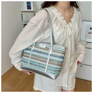 Detail of colorful woven tote bag with silver metallic trim and textured zigzag pattern