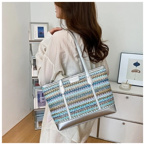 Detail of colorful zigzag woven tote bag featuring silver metallic trim and large capacity