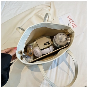 Internal view of a large cream tote bag showing spacious compartments and storage capacity