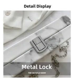 Detail view of marble pattern clutch bag with premium silver hardware and metal chain strap