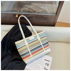 Close-up of the colorful striped woven texture and premium white leather handles
