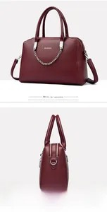 Macro side view of wine red lychee pattern tote bag with silver chain and brand logo