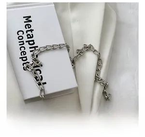Close-up of polished silver metal chain strap for women's crossbody box bag