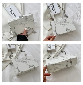 Detailed views of a marble patterned box clutch bag with silver chain and metal clasp