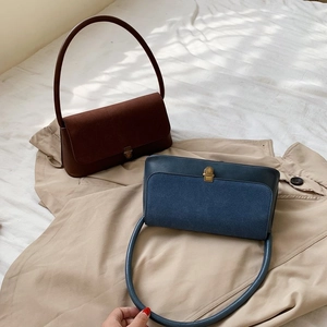 Detail of minimalist rectangular handbags in coffee and blue with vintage metal buckles