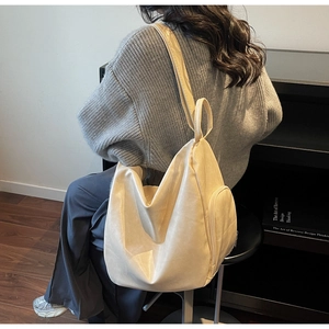 Detail of off-white hobo bag with wide shoulder strap and side zipper pocket