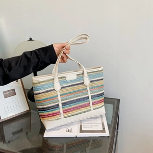 Rainbow striped straw tote bag with white faux leather handles for stylish commuting