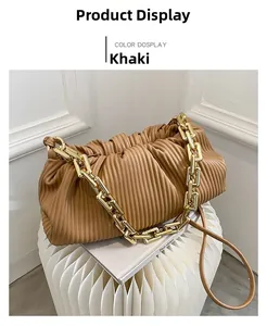 Detail of khaki pleated cloud bag featuring thick gold chain and faux leather straps
