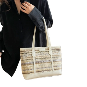 Fashionable oversized straw tote bag with woven multicolored stripes and white leather trim