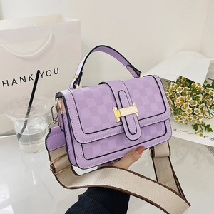 Detail of lilac checkered handbag with wide textile strap and gold buckle closure