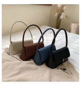 Collection of four minimalist leather underarm bags in beige, brown, blue, and black colors