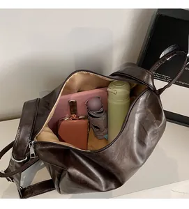 Detail shot of the large capacity interior of this brown leather shoulder bag