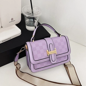 Detailed shot of purple checkered handbag with golden H-clasp and wide woven shoulder strap