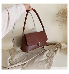 Detail of retro shoulder bags with suede flap and gold square metal buckle closure