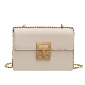 Detail of minimalist cream leather bag showing the golden geometric metal buckle and chain