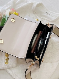 Interior detail of a beige crossbody bag showing ample capacity for daily essentials