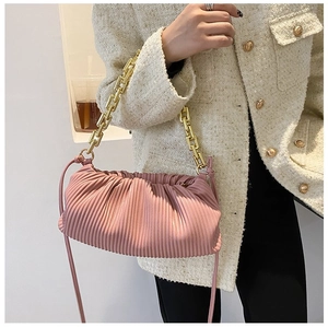 Detailed view of pink pleated cloud bag with chunky gold chain strap and soft PU leather