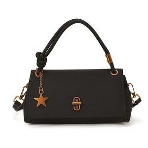 Black pebbled leather tote bag with a gold star pendant and metallic twist lock closure
