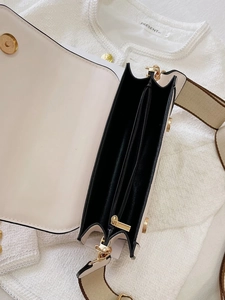 Top view of white crossbody bag showing dual internal compartments and gold zipper