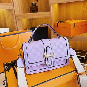 Detail of purple crossbody bag with checkered embossing and golden square metal clasp