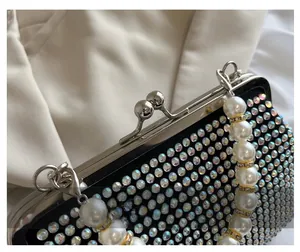 Macro detail of luxury evening bag with iridescent rhinestones and pearl handle strap