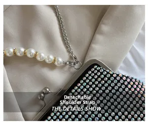 Detail of rhinestone handbag featuring a detachable pearl handle and silver chain strap