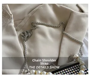 Detailed close-up of shiny rhinestone evening bag with elegant pearl handle and chain strap