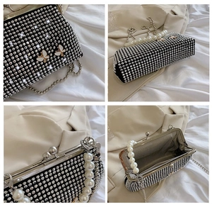Detail of evening bag showing pearl handle, butterfly decor, and rhinestone texture