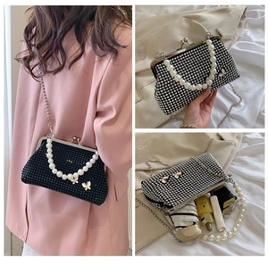 Three-way view of black crystal evening bag with pearl handle and butterfly decor