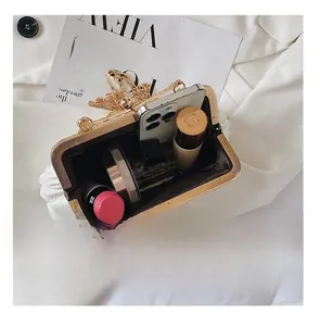 Interior capacity detail showing beige ruched cloud bag with gold chain and cosmetics