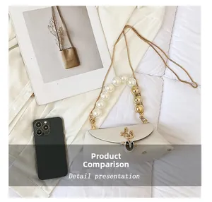 Mini cream handbag with pearl handle and gold chain compared to a smartphone