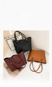 Three large faux leather tote bags in black, burgundy and brown with shoulder straps