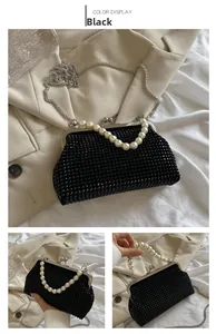 Close-up of black beaded evening clutch featuring pearl handle and vintage metal chain strap
