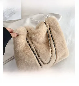 Close-up of beige faux fur texture with black leather and gold chain straps