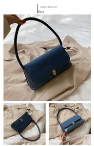Detail of blue faux suede shoulder bag featuring a sleek metal twist lock closure
